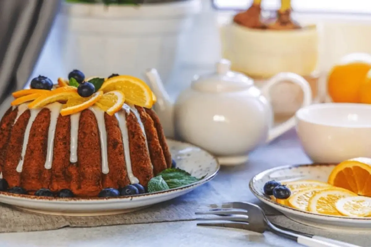 A close-up image of a delicious Bundt cake on a white plate, showcasing its intricate pattern and golden brown color.