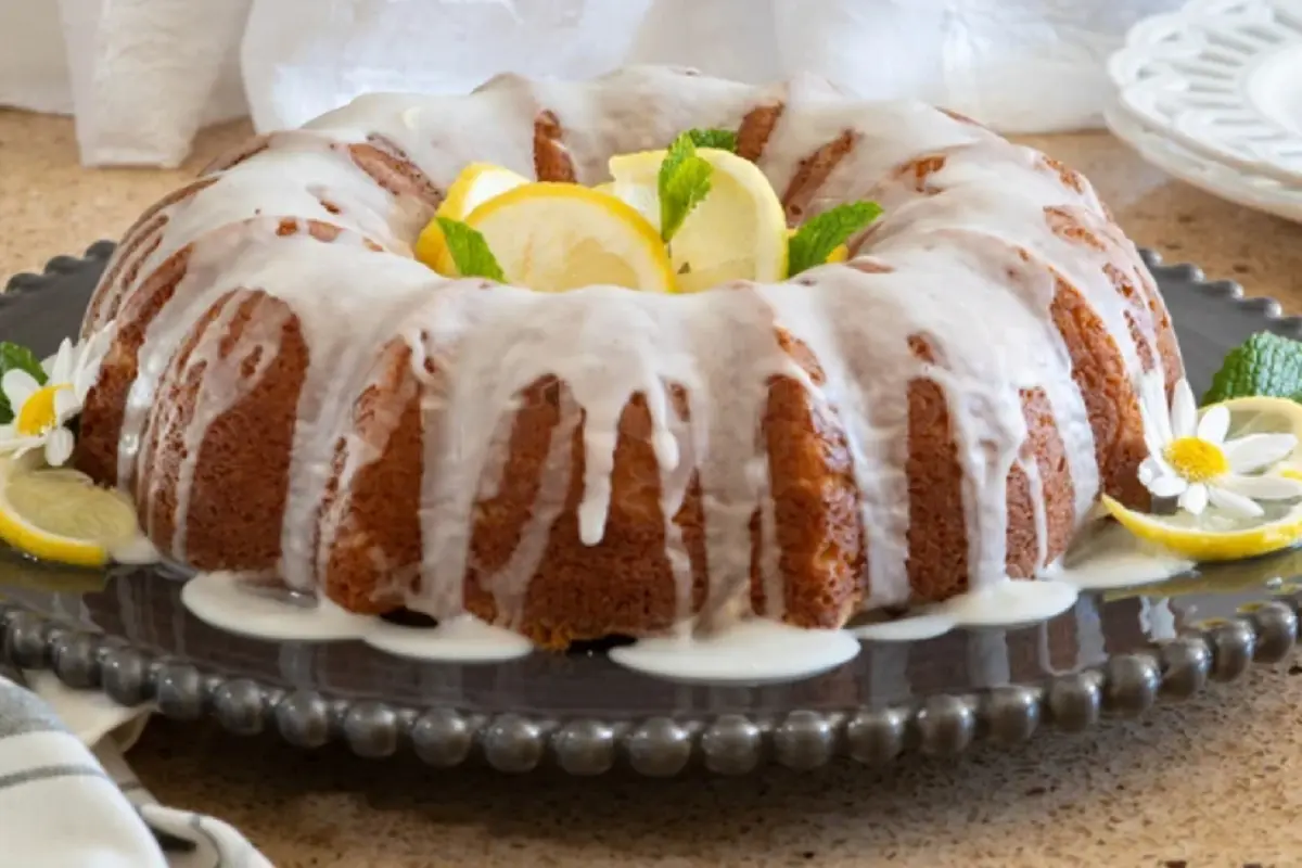 A beautifully baked Bundt cake adorned with fall foliage and cinnamon sticks