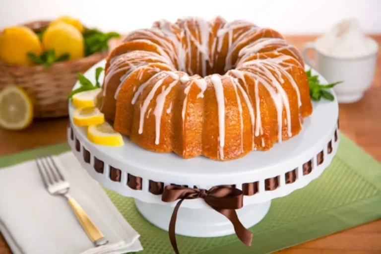 A beautifully baked Bundt cake adorned with fall foliage and cinnamon sticks