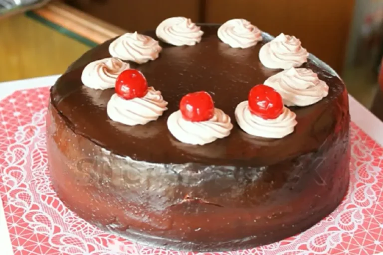 A dry Bundt cake with crumbs on a plate.